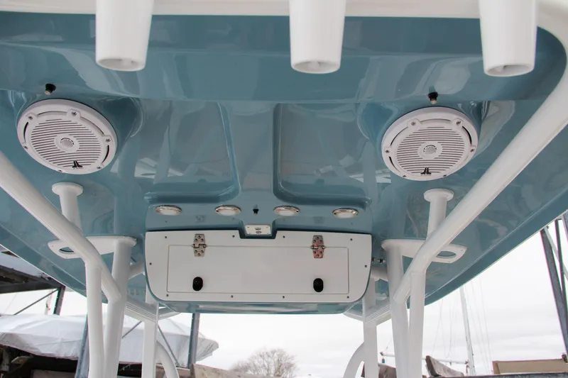 Slide: The Image of 2024 Sea Hunt Ultra 229 boat T-top with speakers and rod holders. - 26