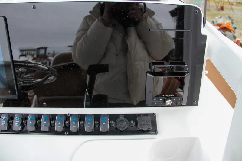 Slide: The Image of Control panel of 2024 Sea Hunt Ultra 229 boat with switches and JL Audio system. - 30