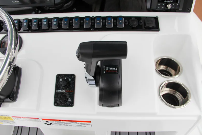 Slide: The Image of 2024 Sea Hunt Ultra 229 boat console with Yamaha controls and cup holders. - 31