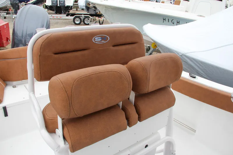 Slide: The Image of 2024 Sea Hunt Ultra 229 boat seating with brown cushions. - 37