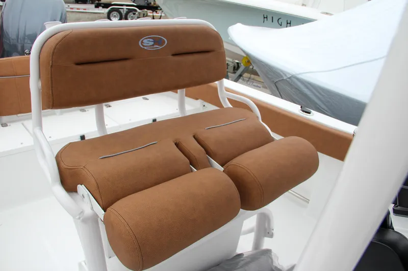 Slide: The Image of 2024 Sea Hunt Ultra 229 boat with brown cushioned seating. - 38