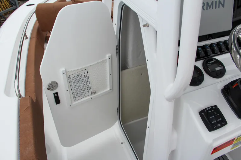 Slide: The Image of 2024 Sea Hunt Ultra 229 boat console with open storage compartment. - 40
