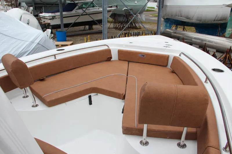 Slide: The Image of 2024 Sea Hunt Ultra 229 boat with brown cushioned seating in the bow area. - 42
