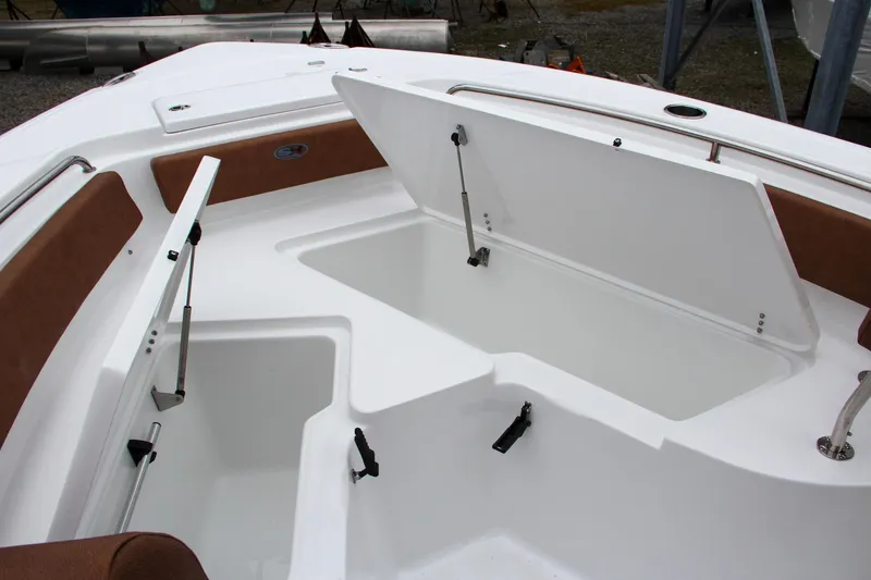 Slide: The Image of 2024 Sea Hunt Ultra 229 boat with open storage compartments. - 44