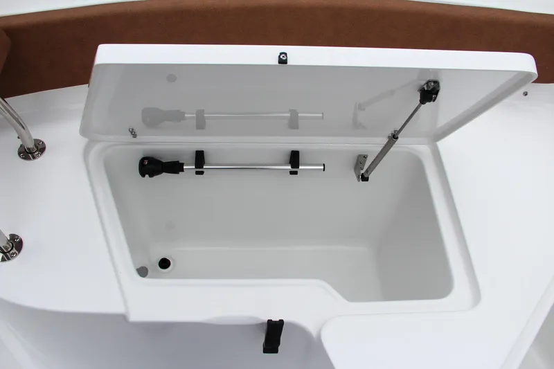 Slide: The Image of 2024 Sea Hunt Ultra 229 storage compartment with open lid. - 46