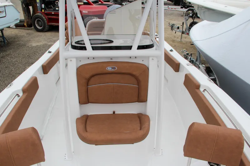 Slide: The Image of 2024 Sea Hunt Ultra 229 boat interior with tan seating and white frame. - 47