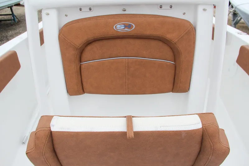 Slide: The Image of 2024 Sea Hunt Ultra 229 boat seating with brown cushions. - 49