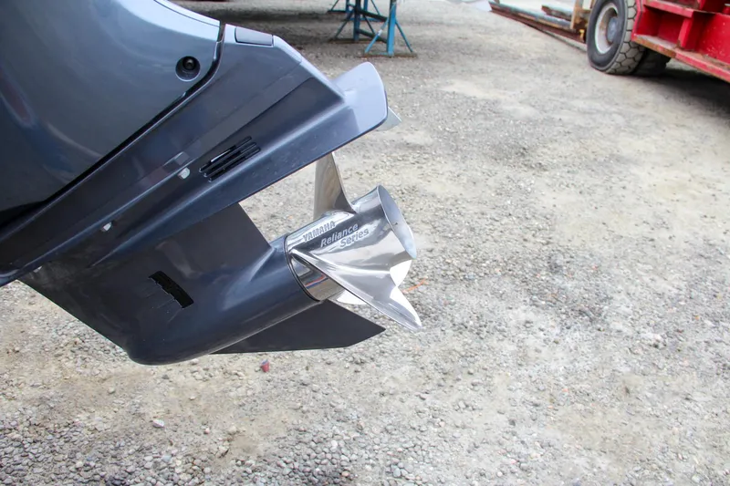 Slide: The Image of Close-up of 2024 Sea Hunt Ultra 229 boat propeller on gravel surface. - 5