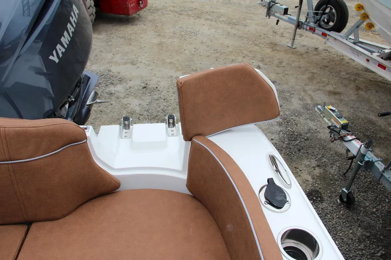 Slide: The Image of 2024 Sea Hunt Ultra 229 boat interior with brown seating and Yamaha engine. - 8