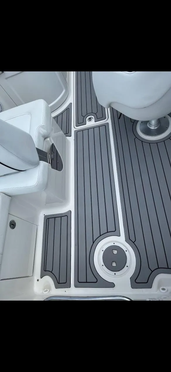 Slide: The Image of 2014 Sea Ray 240 Sundeck interior with gray and white flooring. - 5
