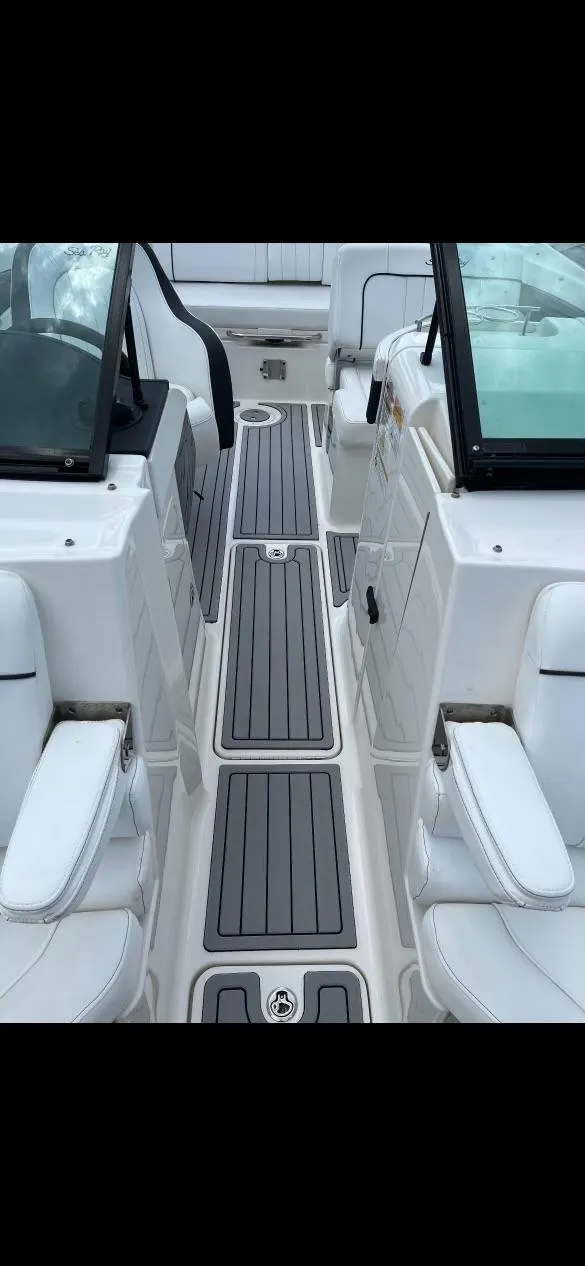 Slide: The Image of 2014 Sea Ray 240 Sundeck interior with white seating and gray flooring. - 6