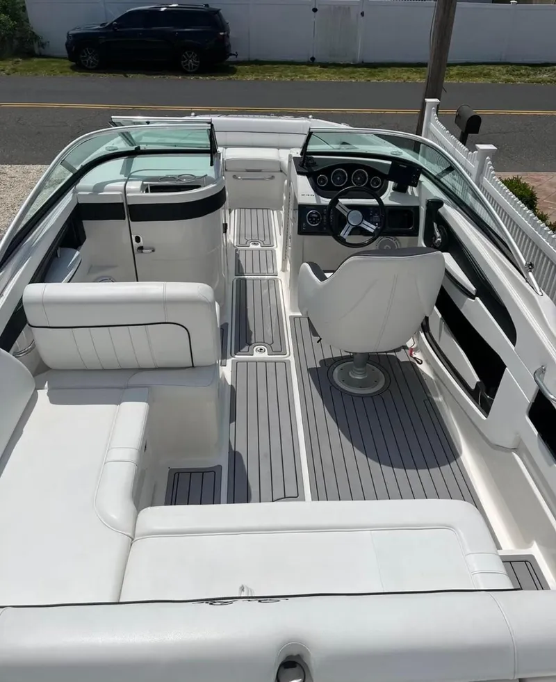 Slide: The Image of 2014 Sea Ray 240 Sundeck boat interior with white seating and modern dashboard. - 7