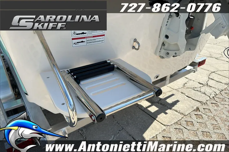 Slide: The Image of 2024 Carolina Skiff E21 DLX CC boat with swim ladder, displayed at Antonietti Marine. - 11