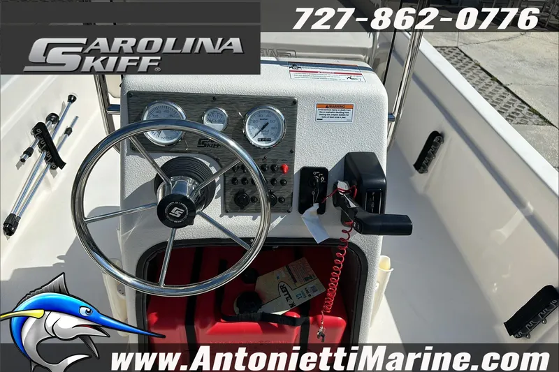Slide: The Image of 2024 Carolina Skiff E21 DLX CC boat dashboard with steering wheel and gauges. - 18