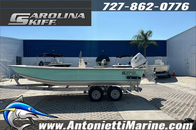 Slide: The Image of 2024 Carolina Skiff E21 DLX CC boat on trailer at Antonietti Marine dealership. - 5