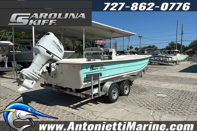 Slide: The Image of 2024 Carolina Skiff E21 DLX CC boat on trailer at Antonietti Marine dealership. - 8