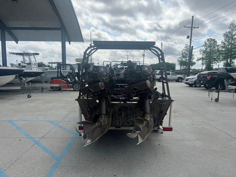 Slide: The Image of 2013 Pro-Drive 20 SBX boat with dual engines, parked in a marina. - 5