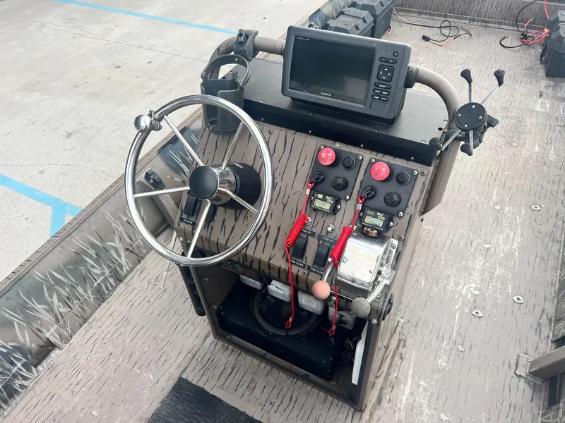 Slide: The Image of 2013 Pro-Drive 20 SBX boat console with steering wheel and navigation equipment. - 7