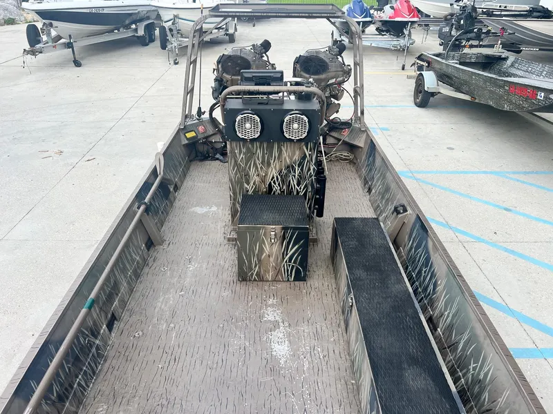 Slide: The Image of 2013 Pro-Drive 20 SBX boat interior with camo design and dual engines. - 8
