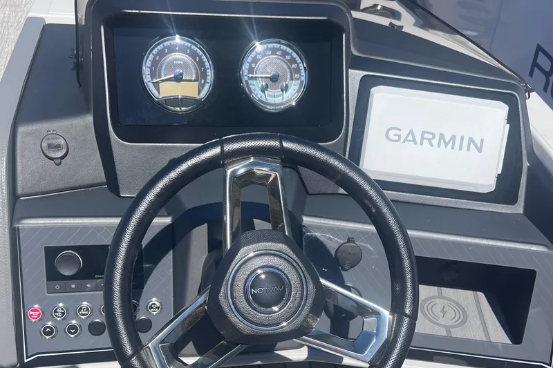 Slide: The Image of 2024 Avalon Catalina Quad Lounge pontoon boat with Mercury engine, docked outdoors. - 16