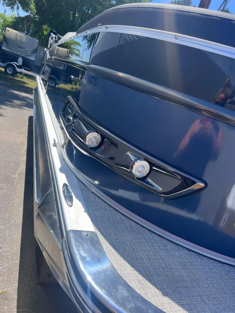 Slide: The Image of 2024 Avalon Catalina Quad Lounge 23' pontoon boat with powerful outboard motor. - 2