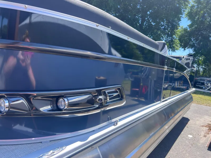 Slide: The Image of 2024 Avalon Catalina Quad Lounge 23' pontoon boat, rear view, docked. - 4