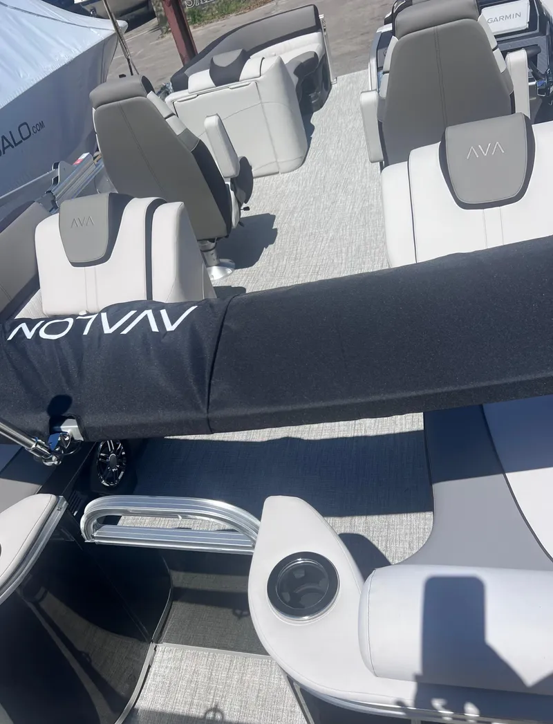 Slide: The Image of 2024 Avalon Catalina Quad Lounge 23' pontoon boat, sleek blue exterior, chrome accents. - 5