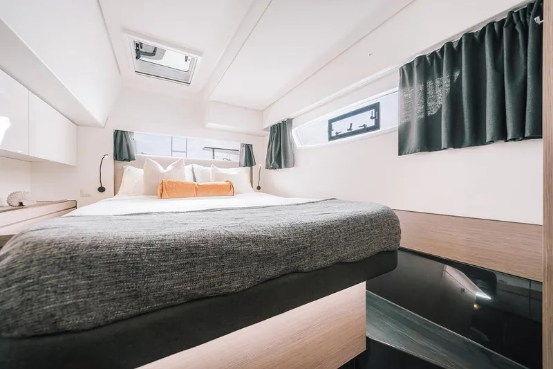 Slide: The Image of Modern bedroom interior of 2024 Fountaine Pajot Tanna 47 catamaran with large bed and windows. - 4