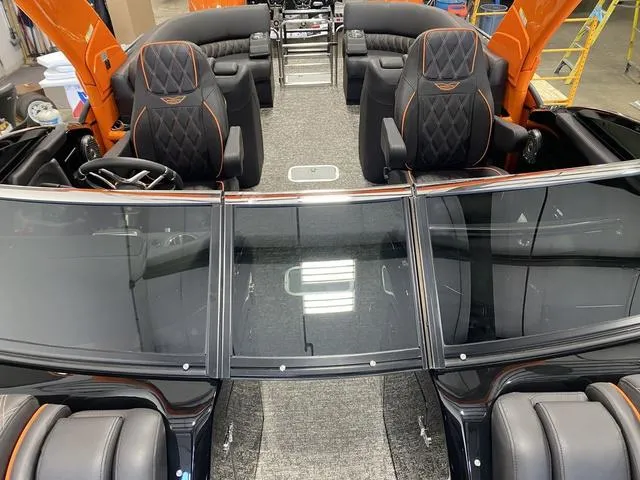 Slide: The Image of 2024 Bennington 27 QXFBWA T2 interior, luxury seating, and modern dashboard. - 11