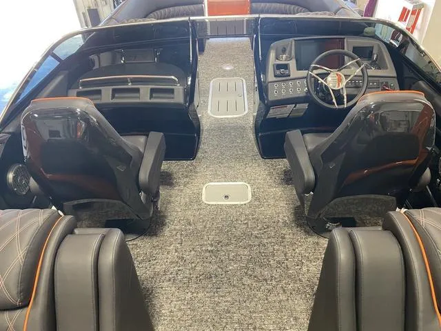 Slide: The Image of 2024 Bennington 27 QXFBWA T2 boat interior with modern dashboard and seating. - 13