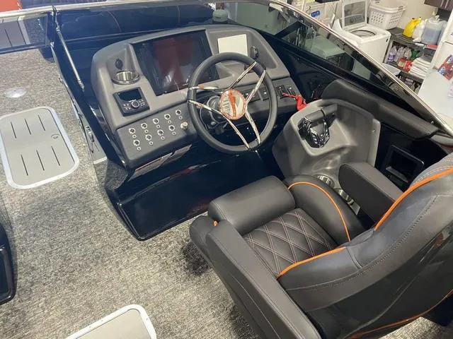 Slide: The Image of 2024 Bennington 27 QXFBWA T2 boat cockpit with modern steering and control panel. - 14