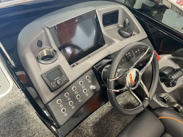 Slide: The Image of 2024 Bennington 27 QXFBWA T2 boat dashboard with steering wheel, touchscreen, and control panel. - 15