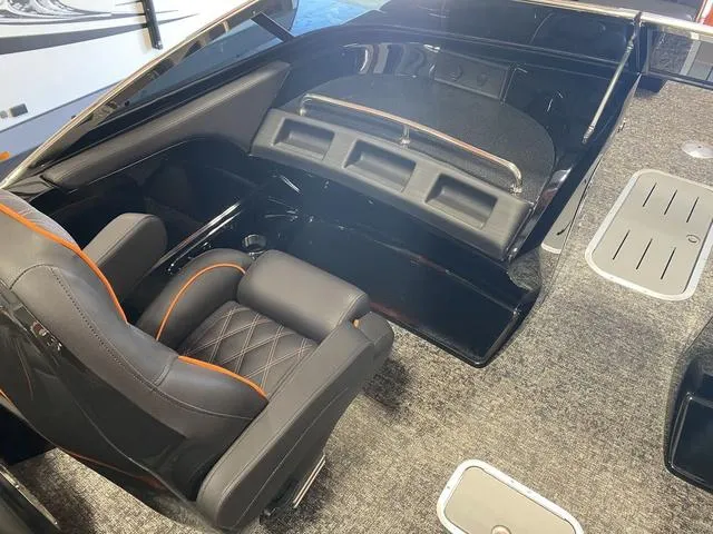 Slide: The Image of 2024 Bennington 27 QXFBWA T2 boat interior with black and orange seating. - 16