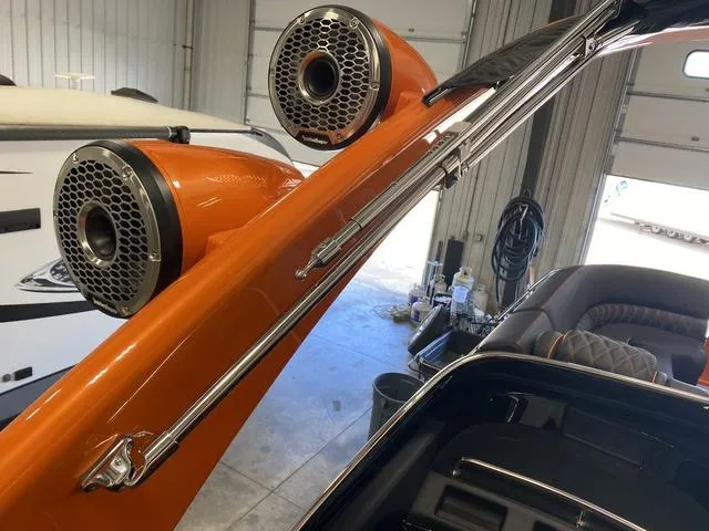 Slide: The Image of 2024 Bennington 27 QXFBWA T2 boat with orange speakers and sleek design. - 24