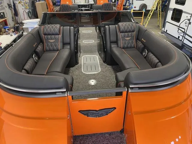 Slide: The Image of 2024 Bennington 27 QXFBWA T2 boat interior with orange and black seating. - 9