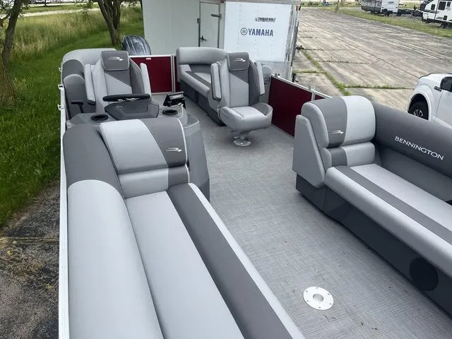 Slide: The Image of 2024 Bennington 22 SVSR pontoon boat interior with gray seating and steering console. - 7