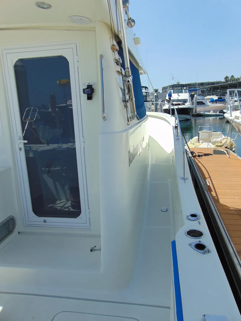 Slide: The Image of 2014 Rodman 1250 ADV Fisher Cruiser docked at marina. - 1