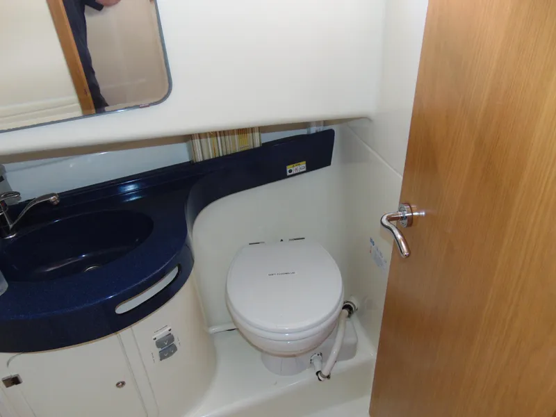 Slide: The Image of Rodman 1250 ADV Fisher Cruiser 2014 bathroom with sink, toilet, and mirror. - 15