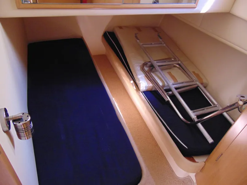 Slide: The Image of Interior cabin of 2014 Rodman 1250 ADV Fisher Cruiser with twin beds and storage. - 17