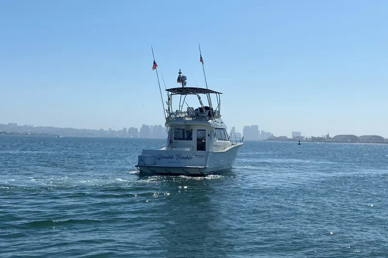 Slide: The Image of Rodman 1250 ADV Fisher Cruiser 2014 on open water with city skyline in background. - 18