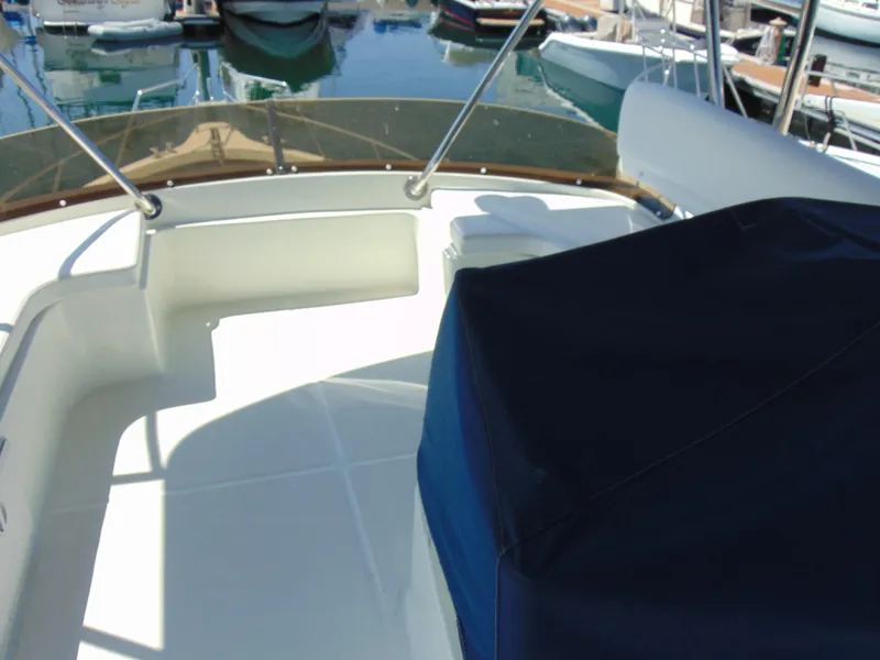 Slide: The Image of Rodman 1250 ADV Fisher Cruiser 2014 boat deck with seating area and covered console. - 21
