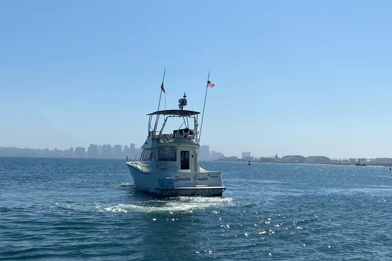 Slide: The Image of Rodman 1250 ADV Fisher Cruiser 2014 on open water with city skyline in background. - 25