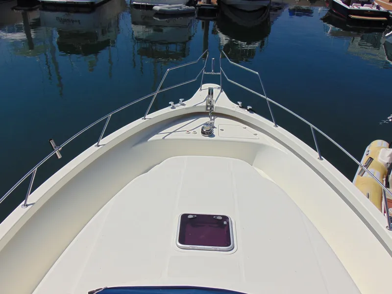 Slide: The Image of Bow view of 2014 Rodman 1250 ADV Fisher Cruiser docked in marina. - 26