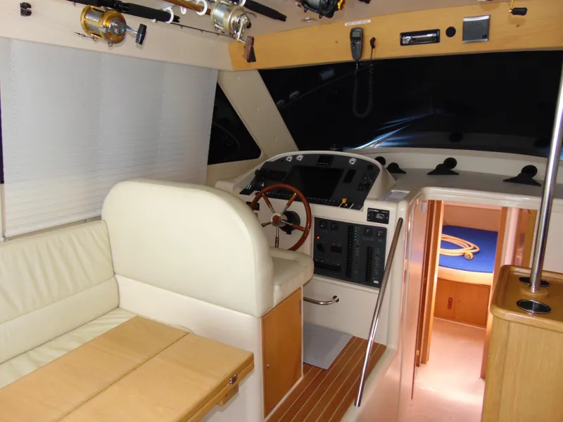 Slide: The Image of Interior of 2014 Rodman 1250 ADV Fisher Cruiser with helm, seating, and fishing rods. - 4