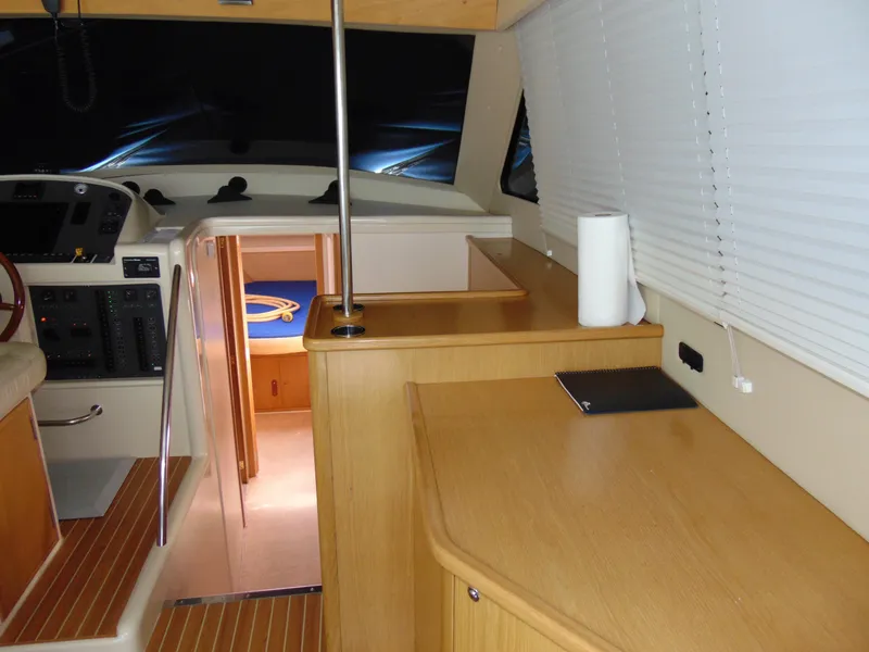 Slide: The Image of Interior of 2014 Rodman 1250 ADV Fisher Cruiser with wooden cabinetry and helm station. - 5