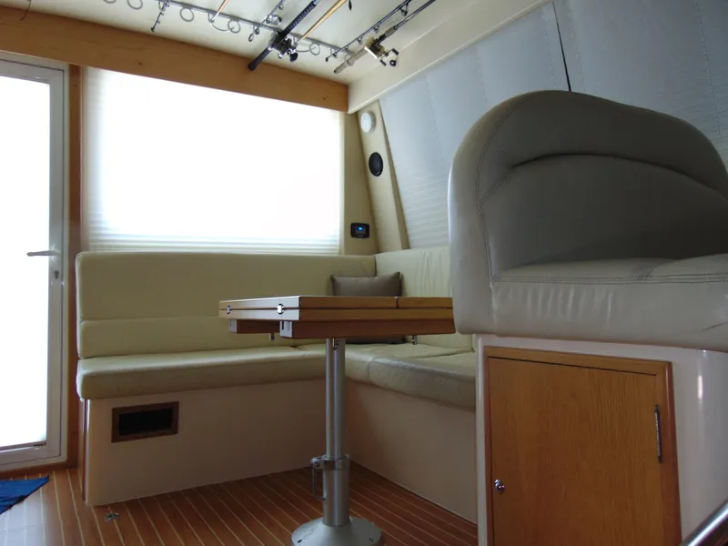Slide: The Image of Interior of 2014 Rodman 1250 ADV Fisher Cruiser with seating and table. - 7