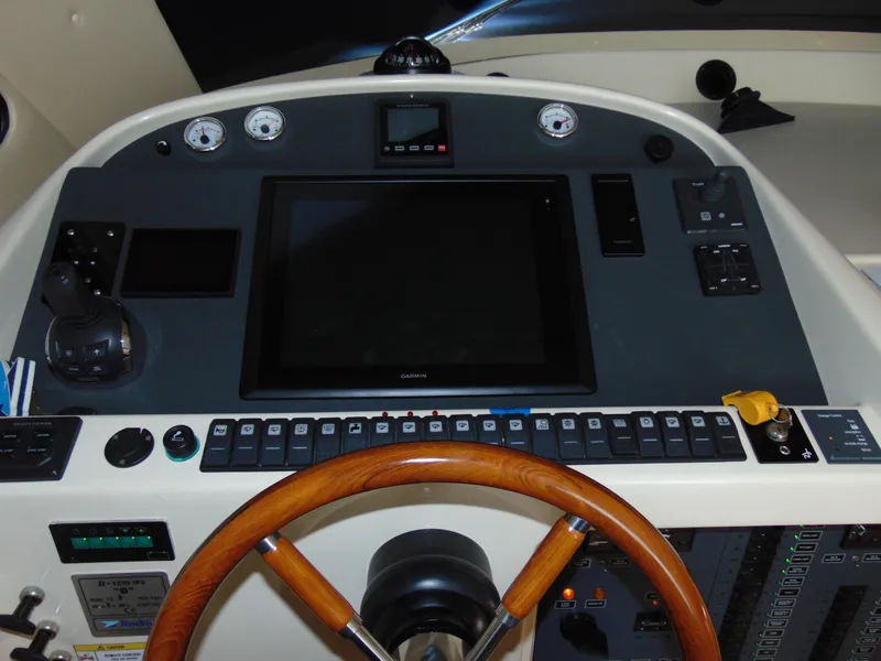Slide: The Image of Control panel of a 2014 Rodman 1250 ADV Fisher Cruiser with wooden steering wheel. - 8