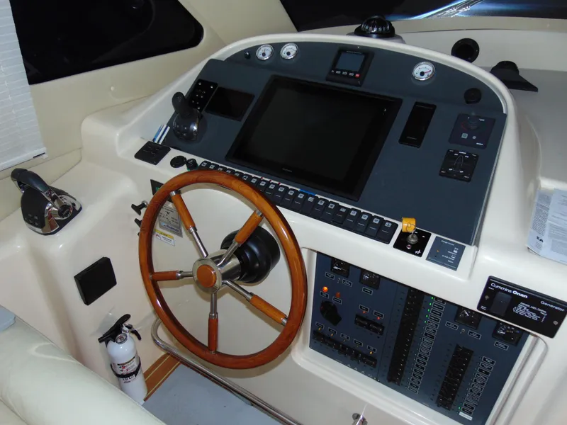 Slide: The Image of Control panel of a 2014 Rodman 1250 ADV Fisher Cruiser with wooden steering wheel. - 9