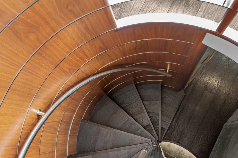 Slide: The Image of Spiral staircase on 2014 Sunseeker 75 Yacht with wooden paneling and metal handrail. - 18