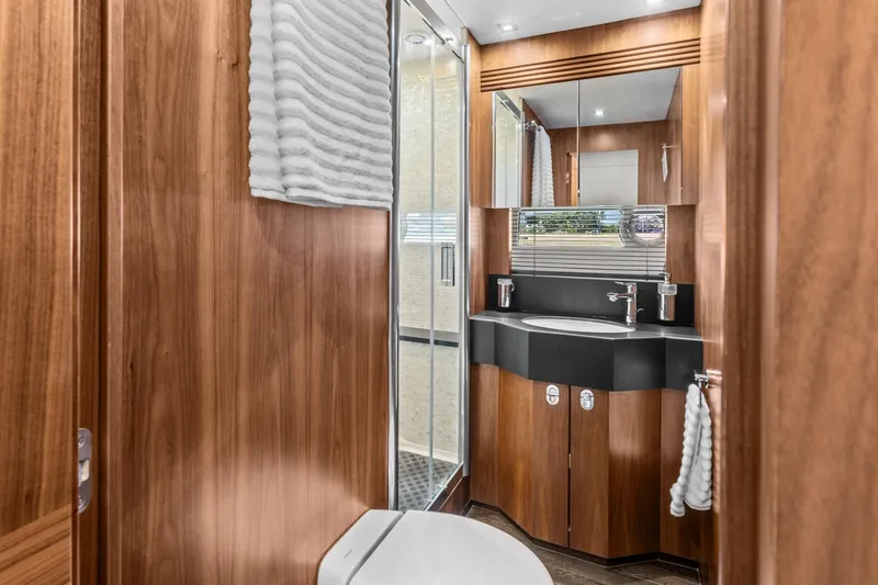Slide: The Image of Luxurious bathroom in 2014 Sunseeker 75 Yacht with wood paneling and modern fixtures. - 25